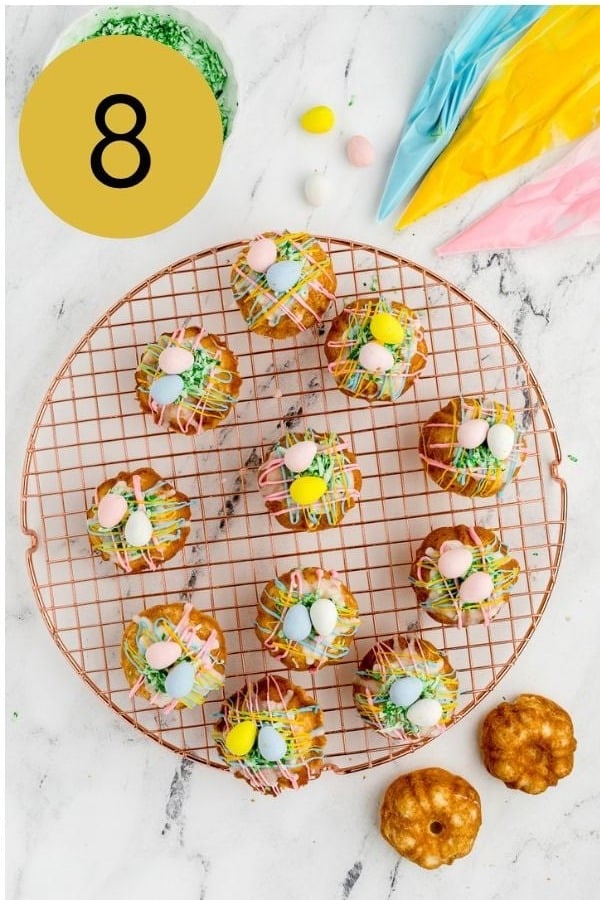 Mini bundt cakes drizzled with colorful candy melts and topped with coconut and candy eggs.